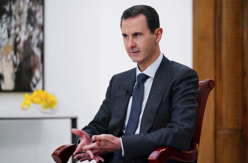 FILE - In this file photo released Monday Nov. 9, 2019 by the Syrian official news agency SANA, Syrian President Bashar Assad speaks in Damascus, Syria. The global chemical weapons watchdog issued a report Wednesday 'April 8, 2020, blaming the Syrian air force for a series of chemical attacks using sarin and chlorine in late March 201.(SANA FILE via AP)