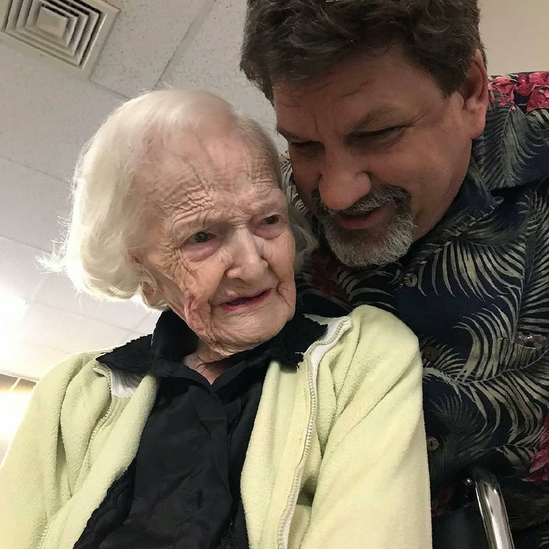 Mary Blount gets a hug from her grandson, Keith Andrews, on her 107th birthday at Briarwood Nursing and Rehabilitation in Little Rock. (Special to the Arkansas Democrat-Gazette) 