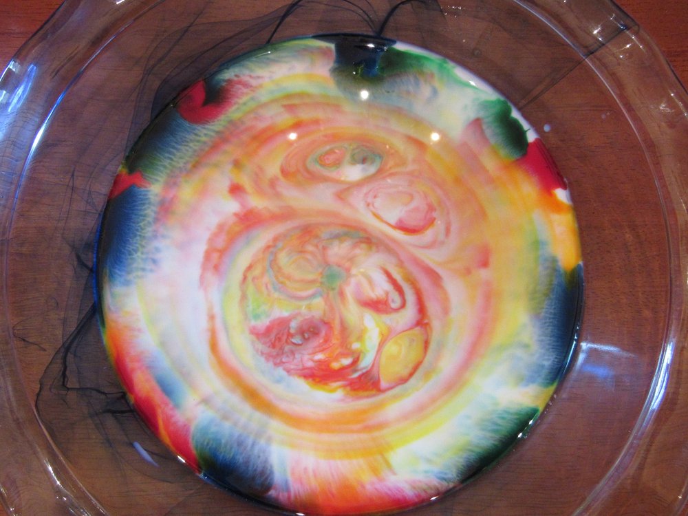 Food colors swirl in a dish of milk as soap comes after their molecules in this science activity for kids stuck at home during the covid-19 crisis. (Special to the Democrat-Gazette/Kimberly Dishongh)