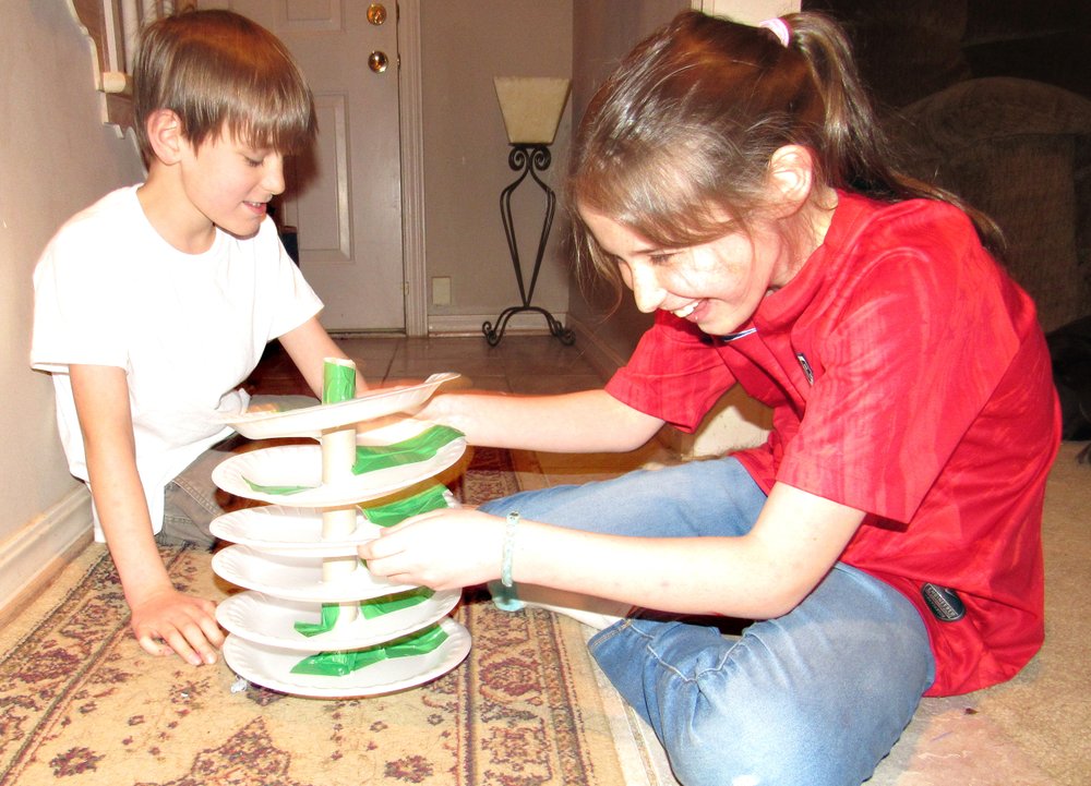 Charlie, 8, and Julianna Dishongh, 10, set up their marble race track in this craft activity for kids stuck at home during the covid-19 crisis. (Special to the Democrat-Gazette/Kimberly Dishongh)