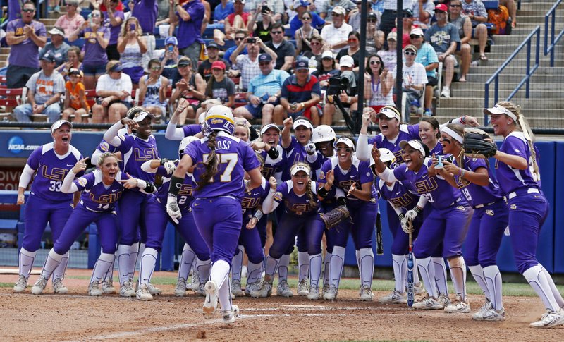 LSU's Kellsi Kloss runs towards home plate where her teammates cheer for her following her home run in the third inning of a May 28, 2015, game against Auburn in the NCAA Women's College World Series in Oklahoma City. LSU won 6-1. To accommodate what were expected to be record crowds, USA Softball Hall of Fame Stadium underwent a 4,000-seat expansion that raised its capacity to about 13,000. All the new seats were already sold out. Turns out, they won't be needed this year. - Photo by Sue Ogrocki of The Associated Press