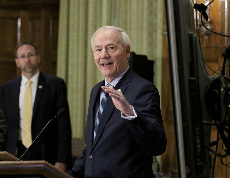 Governor Asa Hutchinson, right, and Dr. Nathaniel Smith, Secretary of the Arkansas Department of Health, updated  media representatives Monday afternoon, April 13, 2020, regarding Arkansass COVID-19 response. The briefing was held at the governor's conference room at the state capitol in Little Rock.