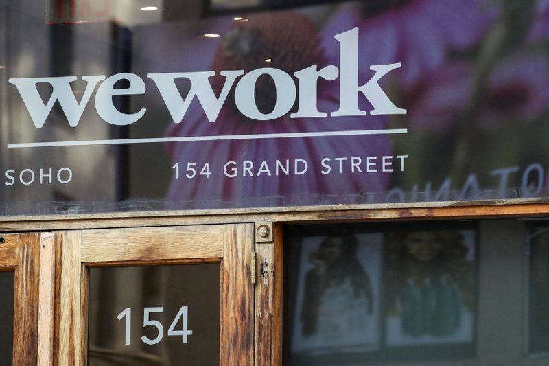 FILE - This Oct. 15, 2019, file photo shows a WeWork logo at the entrance to one of their office spaces in the SoHo neighborhood of New York. (AP Photo/Mary Altaffer, File)