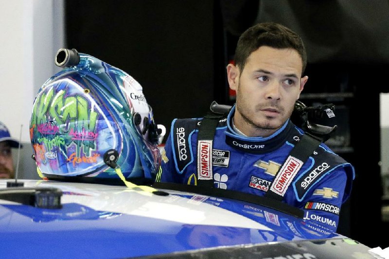 Kyle Larson gets ready to climb into his car to practice for the NASCAR Daytona 500 auto race at Daytona International Speedway, Friday, Feb. 14, 2020, in Daytona Beach, Fla. (AP Photo/Terry Renna)