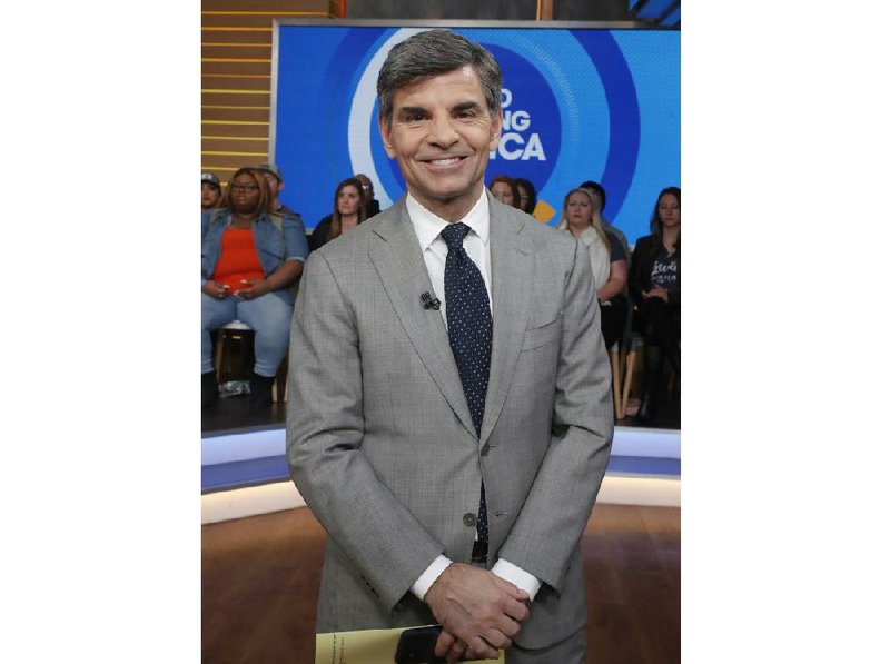 This Feb. 24, 2020 photo released by ABC shows co-host George Stephanopoulos on the set of "Good Morning America" in New York. Stephanopoulos says he has tested positive for the coronavirus, but is relatively symptom-free. He said on Monday's show that other than a brief backache and diminished sense of smell, he's been feeling fine. His wife, journalist Ali Wentworth, has the disease and has said she's never felt sicker. Stephanopoulos made the announcement on the show Monday.  (Lou Rocco/ABC via AP)