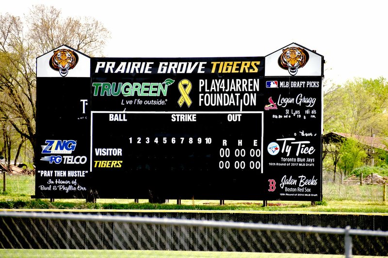 MARK HUMPHREY ENTERPRISE-LEADER Prairie Grove baseball coach Mitch Cameron updated the scoreboard at Rieff Park displaying the names of three former Tiger pitchers: Logan Gragg, St. Louis Cardinal 2019; Ty Tice, Toronto Blue Jays 2017; and Jalen Beeks, Boston Red Sox 2014; who were drafted by Major League Baseball.