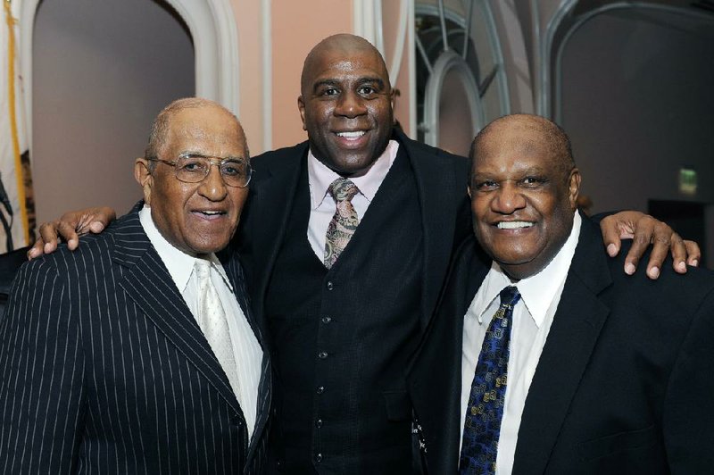 In this file photo Earvin "Magic" Johnson is joined by (left) Don Newcombe of the L.A. Dodgers and Willie D. Davis (right) formerly of the Green Bay Packers.  (AP Photo/Earl Gibson III)