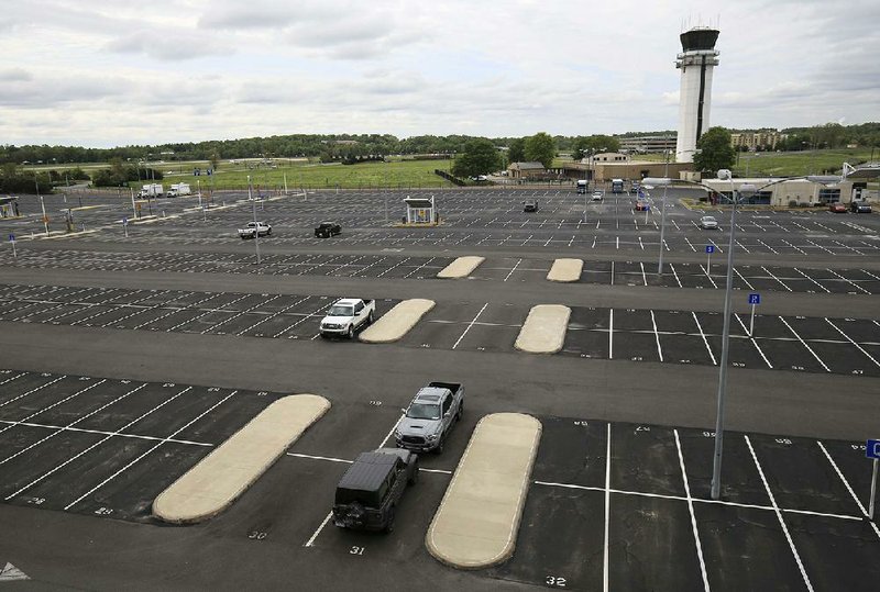 Only a few cars are parked in a lot Tuesday at Bill and Hillary Clinton National Airport/Adams Field in Little Rock. Travel restrictions since the onset of the coronavirus pandemic have eliminated more than 90% of the airport’s passenger traffic. (Arkansas Democrat-Gazette/Staton Breidenthal) 