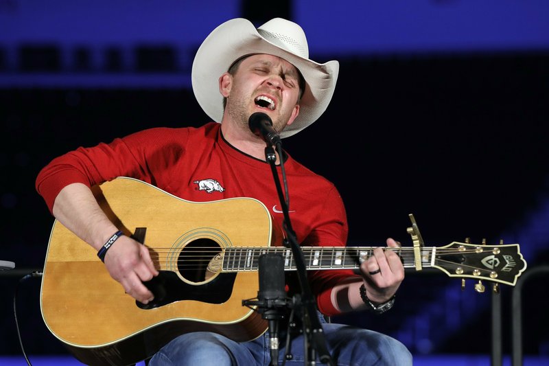 Justin Moore, as seen from backstage, performs at Simmons Bank Arena in North Little Rock for an audience of 10 on Saturday night. Some 100,000 viewers checked out the virtual concert on Facebook, where it is still available to watch. Donations to Food Banks of Arkansas can still be made by texting FEED to 501501 or by visiting foodbanksofarkansas.com.

(Special the Democrat-Gazette/Nelson Chenault)