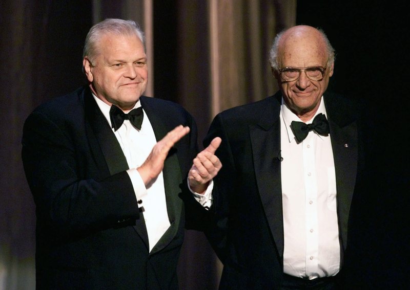 FILE - In this June 6, 1999 file photo, actor Brian Dennehy, left, applauds playwright, Arthur Miller, before awarding him the Lifetime Achievement Award at the Tony Awards in New York. Dennehy, the burly actor who started in films and later in his career won plaudits for his stage work in plays, died of natural causes on Wednesday, April 15, 2020 in New Haven, Conn. He was 81. (AP Photo/Kathy Willens, File)
