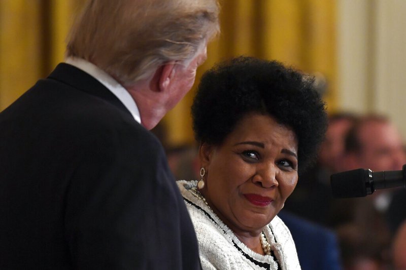 FILE - In this April 1, 2019, file photo President Donald Trump, left, listens as former prisoner Alice Marie Johnson, right, speaks at the 2019 Prison Reform Summit and First Step Act Celebration in the East Room of the White House in Washington. The 64-year-old African American great-grandmother spent 21 years in prison for a nonviolent drug offense before Trump commuted her sentence in 2018. (AP Photo/Susan Walsh, File)