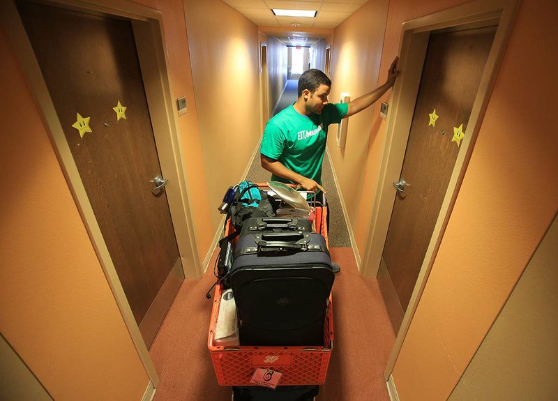 Esteban Rodriguez waits at the door in a dorm on the University of Arkansas at Little Rock campus in this 2013 file photo.