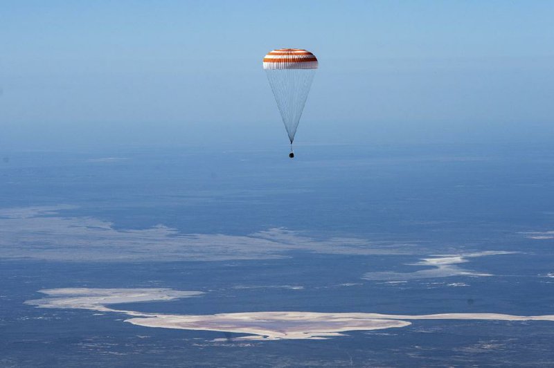 The Soyuz MS-15 space capsule carrying International Space Station crew members descends for a landing Friday in a remote area near Dzhezkazgan, Kazakhstan. More photos at arkansasonline.com/418nasa/
(AP/Roscosmos space agency/Andrey Shelepin)