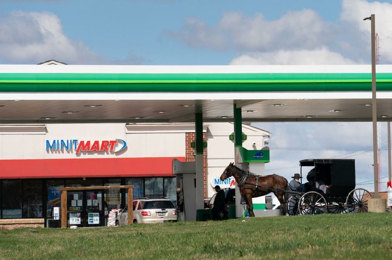 An Amish couple make a stop at a Minit Mart In Wooster, Ohio on April 2. On March 16, Ohio public health officials advised against gatherings of 10 or more people. Four days later, the state’s Amish steering committee advised all church districts to pay heed.
(The New York Times/Erin Schaff)