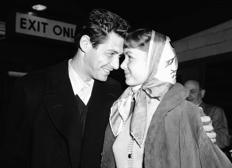 Singer Eddie Fisher and his fiancee, actress Debbie Reynolds, have eyes only for each other at Idlewild Airport on April 19, 1955, in New York on arriving by plane from England. Fisher performed at the London Palladium and both he and Reynolds appeared in a command performance for Queen Elizabeth II. (File Photo/AP) story.lead_photo.caption