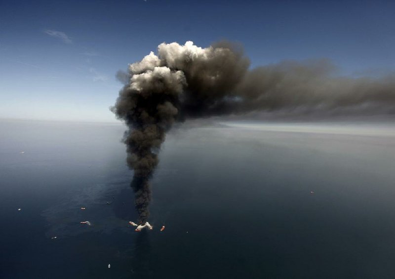 This April 2010 file photo shows the Deepwater Horizon oil rig burning in the Gulf of Mexico, more than 50 miles southeast of Venice on Louisiana’s tip. More photos at arkansasonline.com/419bpspill/
(AP/Gerald Herbert)