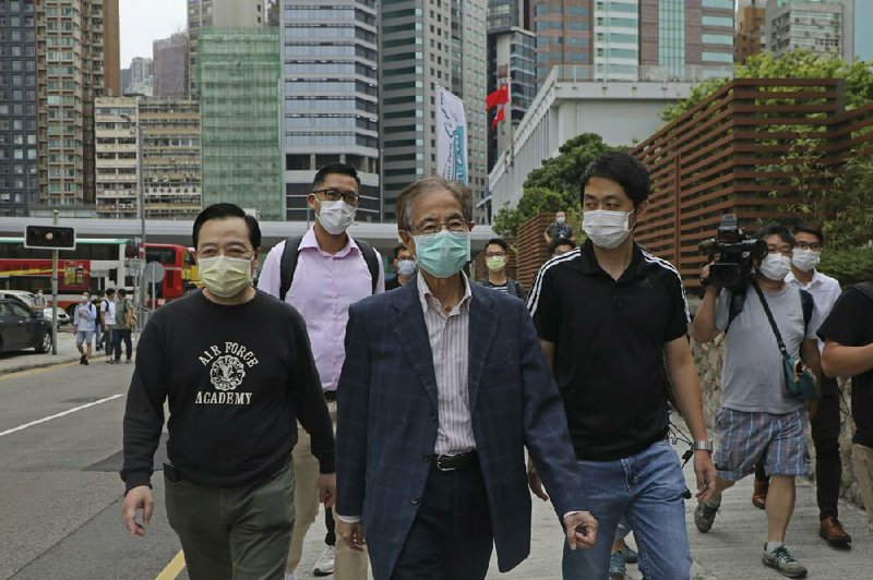 Former pro-democracy lawmaker Martin Lee (center) leaves a police station Saturday in Hong Kong. More photos at arkansasonline.com/419hongkong/.
(AP/Kin Cheung)