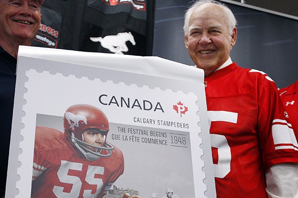 Former Calgary Stampeders linebacker Wayne Harris is shown in 2012 with a stamp that commemorated his playing days in the Canadian Football League.
