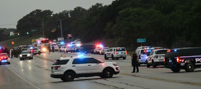 Authorities gather Saturday near the site of the shooting in San Marcos, Texas. (AP/San Marcos Daily Record/Lance Winter) 

