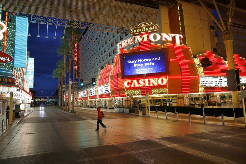 A man walks along Fremont Street in downtown Las Vegas after casinos were ordered to shut down due to the coronavirus outbreak in this March 21, 2020, file photo.