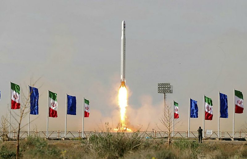 A rocket blasts off from a mobile launcher at a site believed to be in Iran’s Semnan province in this photo released Wednesday. Iran’s Revolutionary Guard said the rocket carried the Islamic Republic’s  military satellite into orbit.
(AP/Sepahnews)