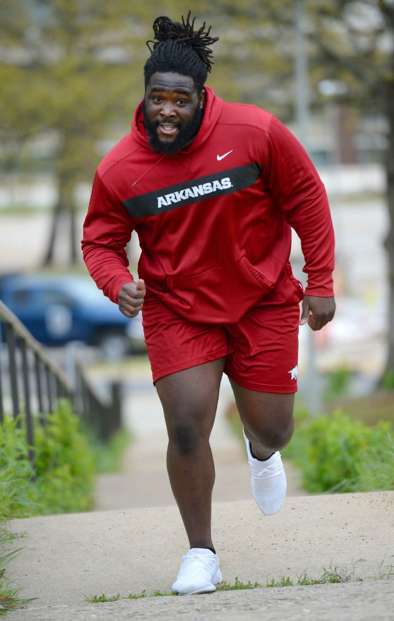 Former Arkansas defensive lineman McTelvin Agim of Texarkana, Texas, sprints Friday, April 17, 2020, up the last of several flights of stairs on the University of Arkansas campus in Fayetteville. Agim is the highest-projected Razorback for the 2020 Draft. 