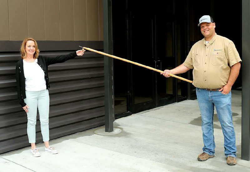 Mid-America Science Museum Executive Director Diane LaFollette receives the keys Thursday to the facility’s new traveling exhibit hall from Integrity Construction Project Manager Bryan Messersmith.
(The Sentinel-Record/Richard Rasmussen)