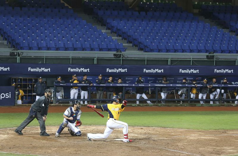 A pair of Chinese Professional Baseball League teams play with no audience at Xinzhuang Baseball Stadium in New Taipei City, Taiwan on Friday. Taiwan’s five-team Chinese Professional Baseball League is barring spectators over concerns they would spread the deadly coronavirus, meaning games are played with plastic seats void of fans. 
(AP/Chiang Ying-ying) 