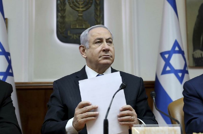 FILE - In this Feb. 16, 2020, file, photo, Israeli Prime Minister Benjamin Netanyahu chairs the weekly cabinet meeting, in Jerusalem. Several thousand Israelis have demonstrated Saturday, April 25, 2020 against a unity government deal reached last week that leaves Prime Minister Benjamin Netanyahu in power as he prepares to go on trial for corruption charges. The protesters say the unity government agreement â€œcrushes democracyâ€ and is meant to rescue Netanyahu from his legal troubles. (Gali Tibbon/Pool via AP, File)
