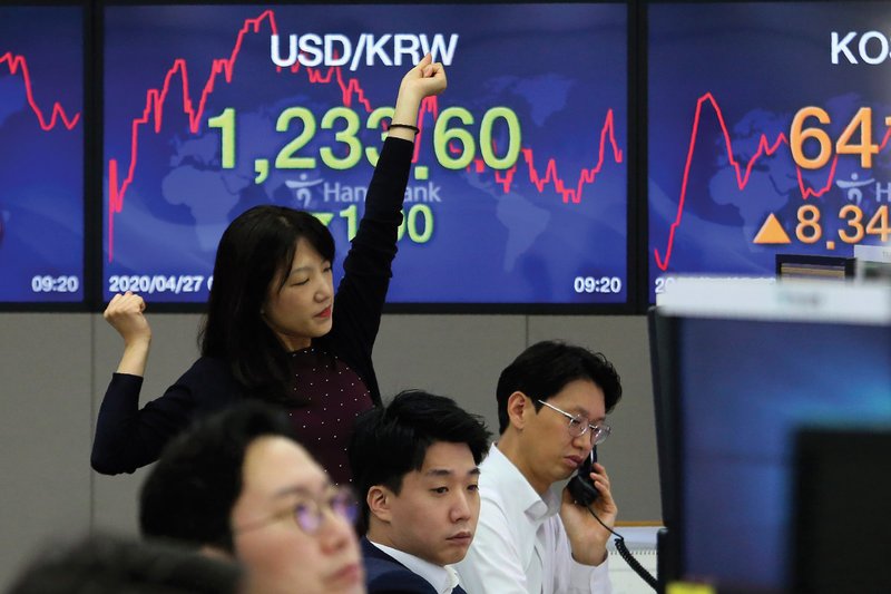 A currency trader stretches Monday while working in the foreign exchange dealing room of the KEB Hana Bank headquarters in Seoul, South Korea.
(AP/Ahn Young-joon)