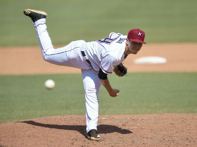 Former Arkansas State and White Hall standout Tyler Zuber, here pitch- ing for the Northwest Arkansas Naturals last year, has been prepar- ing himself for the day when he can resume his minor-league career. (NWA Democrat-Gazette/Charlie Kaijo) 