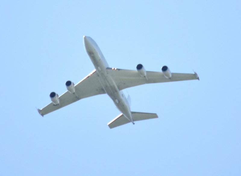 Westside Eagle Observer/MIKE ECKELS A Boeing E-6B Mercury airborne command post flies over Decatur April 21 after a training exercise at Northwest Arkansas Regional Airport in Highfill. The E-6B, the military version of the popular commercial jet liner 707-320, was flying at 3,000 to 3,500 feet (the legal pattern altitude at XNA) when it made this pass over the area.