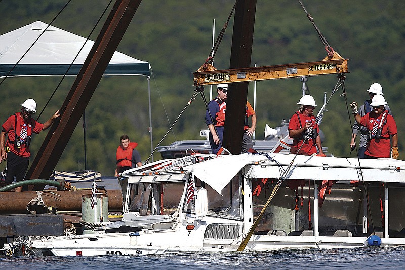 A duck boat that sank in Table Rock Lake in Branson, Mo., is raised in July 2018 after it went down July 19 during a thunderstorm generating near-hurricane strength wind. (File Photo/The Springfield News-Leader/Nathan Papes)