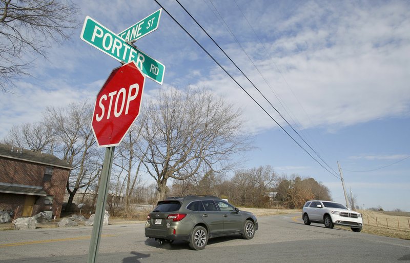 Traffic moves Jan. 31, 2019, on Porter Road and Deane Street in Fayetteville. The city's Transportation Committee on Tuesday reviewed concepts for the planned Midtown Trail corridor stretching from Interstate 49 east to College Avenue. (File photo/NWA Democrat-Gazette/David Gottschalk)