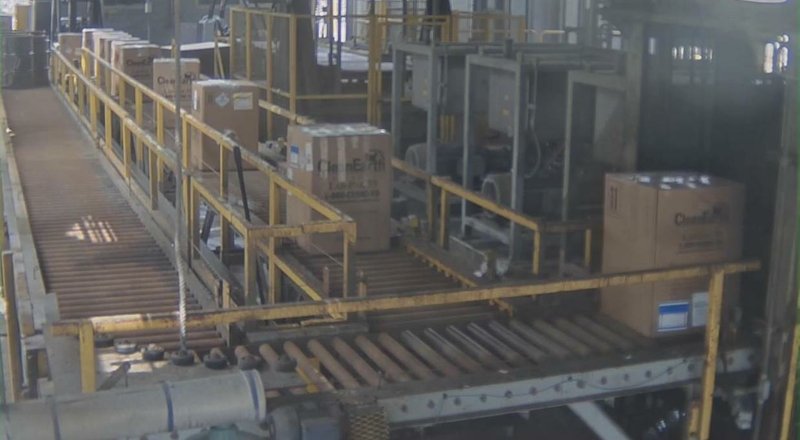 A facility photograph shows containers of covid-19 medical waste on a conveyor heading toward an incinerator inside the Clean Harbors hazardous waste plant in El Dorado.