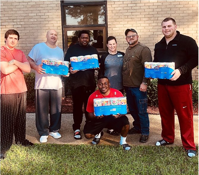 This April 16 photo shows Interfaith Clinic executive director Jill Temple, center, delivering a shipment of Clorox Wipes to the Wings to Recover facility, a men's re-entry facility for those re-joining society after a period of incarceration. The Interfaith Clinic is a SHARE Foundation agency, and the wipes were donated to the SHARE Foundation by Americares, a nonprofit disaster relief and global health organization. - Contributed photo