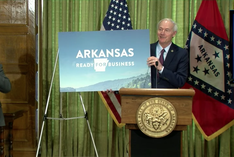 Gov. Asa Hutchinson holds an Arkansas Ready for Business sign during a Wednesday, April 29, briefing in Little Rock. (Photo courtesy Arkansas Governor's Office)
