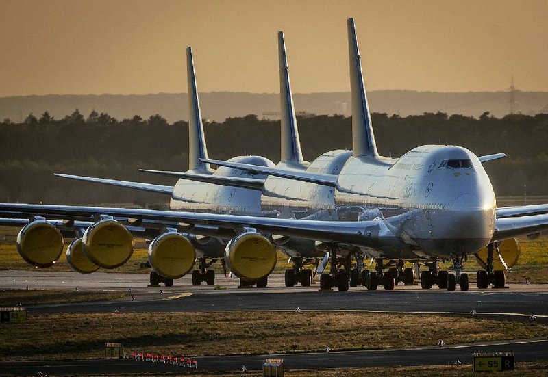 Boeing 747s operated by Lufthansa are parked last week at the airport in Frankfurt, Germany. Boeing’s airline customers are struggling with an unprecedented decline in air travel because of the coronavirus pandemic. More photos at arkansasonline.com/430cut.
(AP/Michael Probst)