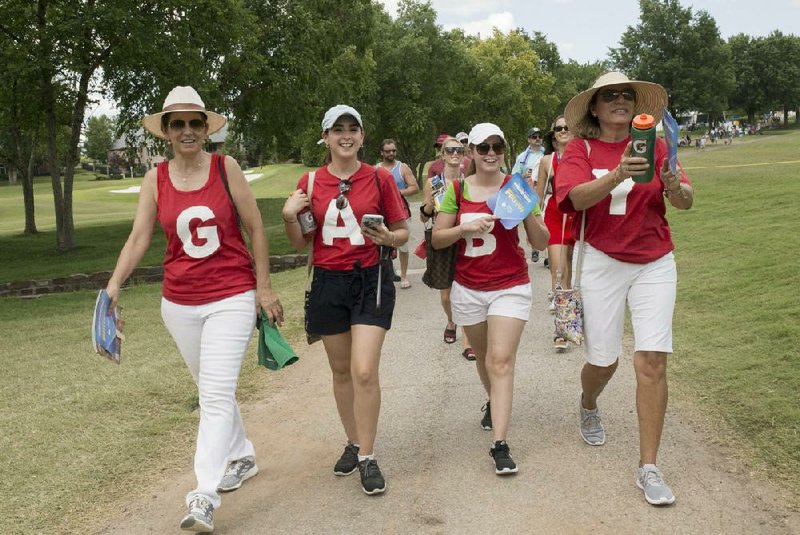 Fans follow former Arkansas Razorbacks golfer Gaby Lopez through the 18th hole during the final round of last year’s Northwest Arkansas Championship in Rogers. Those wanting to do the same this year will have to wait a little longer after the tournament was postponed Wednesday to the final weekend in August.
(NWA Democrat-Gazette/CHARLIE KAIJO)