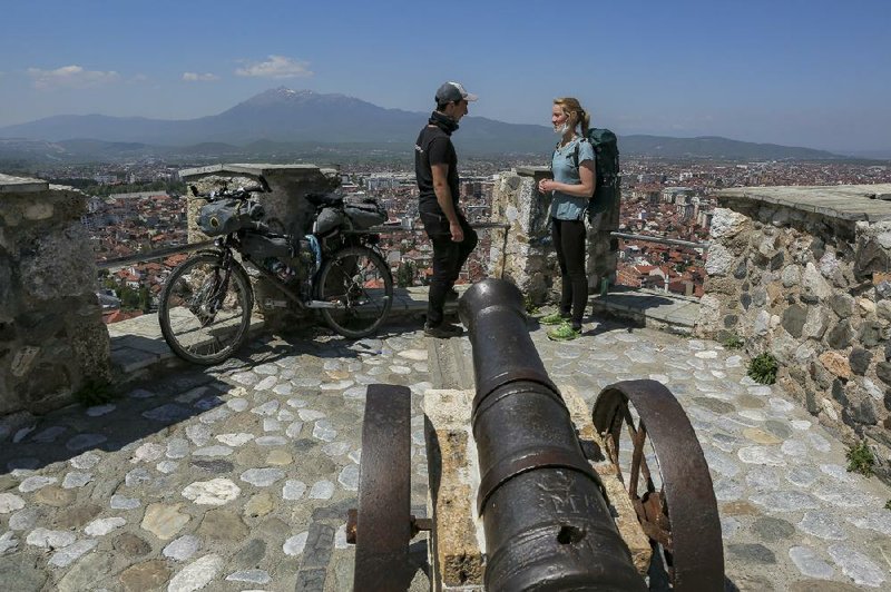 U.K. climate activists Rosie Watson and Mike Elm stand Friday atop the medieval fortress in Prizren, Kosovo. More photos at arkansasonline.com/430kosovo/.
(AP/Visar Kryeziu)
