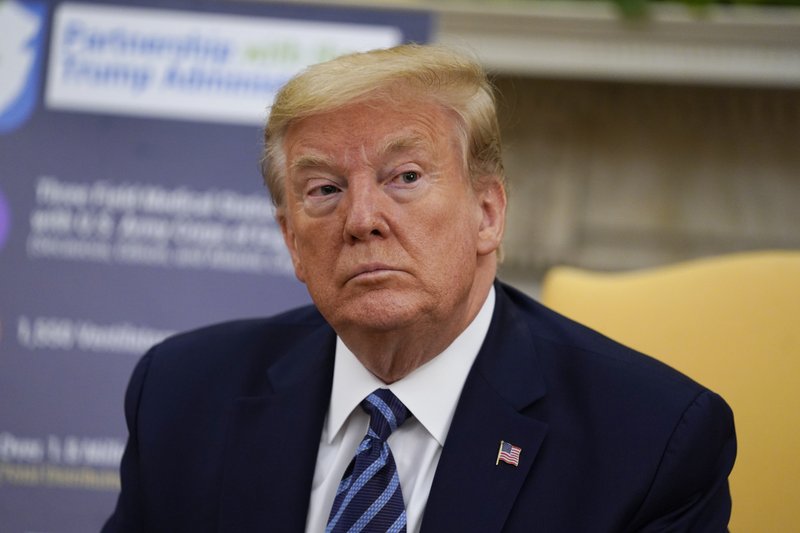 President Donald Trump listens during a meeting about the coronavirus response with Gov. Phil Murphy, D-N.J., in the Oval Office of the White House, Thursday, April 30, 2020, in Washington. (AP Photo/Evan Vucci)