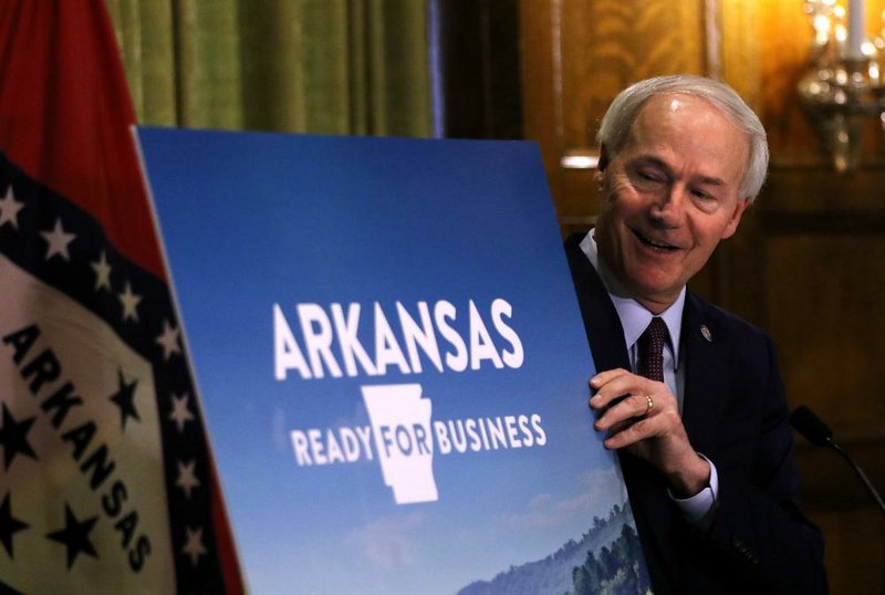 FILE — Gov. Asa Hutchinson shows the slogan for the state’s plan to gradually reopen commerce in this April 29, 2020 file photo.
(Arkansas Democrat-Gazette/Thomas Metthe)