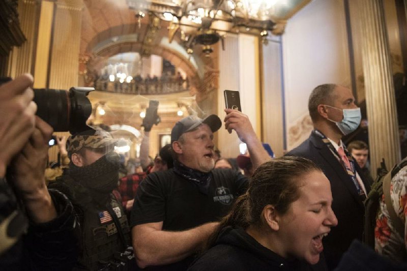 Protesters congregate Thursday inside the Michigan state Capitol after a protest on the lawn. Some demanded to be let onto the state House floor in violation of the rules.
(AP/MLive.com/Ann Arbor News/Nicole Hester)