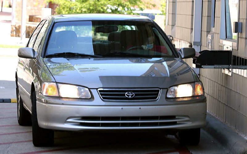 In this file photo a library patron picks up her materials at a drive-thru window at the Main Library branch of the Central Arkansas Library System in Little Rock.
(Arkansas Democrat-Gazette/Thomas Metthe)