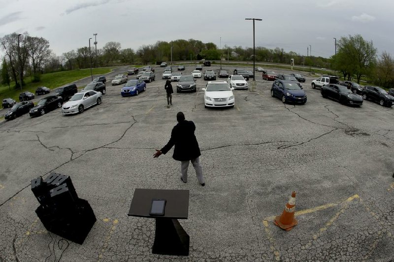 Pastor W.R. Starr II preaches during a drive-in Easter Sunday service while churchgoers listen from their cars in the parking lot at Faith City Christian Center in Kansas City, Kan., in April. As states grapple with when and how to reopen establishments amid the coronavirus pandemic, churches and nonprofits across the country are defending their religious freedom in court, finding success in the less polarizing practice of a drive-in worship designed to gather the faithful in person, at a distance.
(AP/Charlie Riedel)