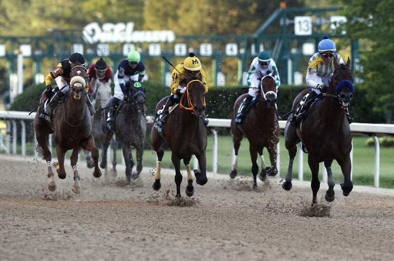 Nadal and jockey Joel Rosario (right) cross the line ahead of King Guillermo and Samy Camacho to win the second division of the Arkansas Derby on Saturday at Oaklawn in Hot Springs. Hall of Fame trainer Bob Baffert swept both Arkansas Derby divisions. More photos available at arkansasonline.com/53derby. (Arkansas Democrat-Gazette/Thomas Metthe) 
