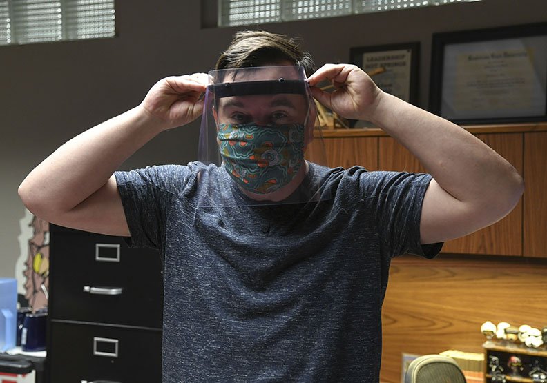 Garland County Library Director Adam Webb models a face shield on Tuesday, April 28, that was produced by one of the library's 3D printers. The protective equipment went to local health care workers and first responders. - Photo by Grace Brown of The Sentinel-Record