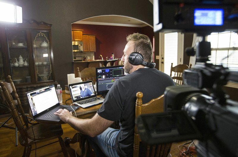 Travis Sherman, a television production teacher at Har-Ber High School in Springdale, broadcasts a lesson April 17 at his home in Bentonville. Sherman has been doing the broadcasts three times a week since schools closed to prevent the spread of covid-19. Go to nwaonline.com/photos to see more photos. (NWA Democrat-Gazette/Ben Goff)