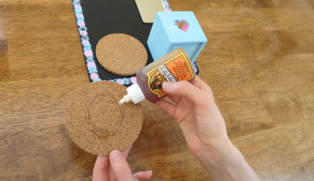 6. Glue the cork discs, one on top of the other, on the bottom left of the chalkboard. Let all glued items dry flat for two hours. (Photo for The Washington Post by Kris Coronado)