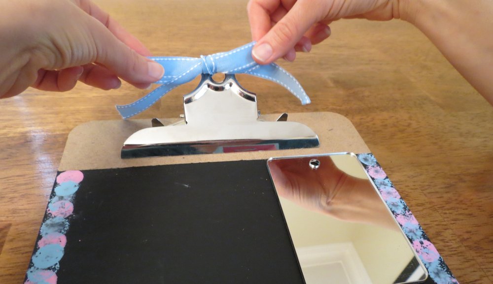 7. Use the ribbon to tie a bow through the clipboard clamp hole. (Photo for The Washington Post by Kris Coronado)